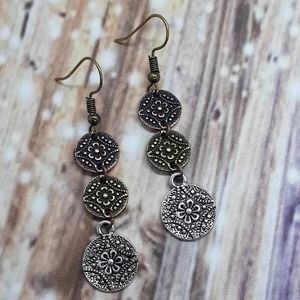 Mixed metal earrings with copper, bronze and silver flower pendants. Dainty.
